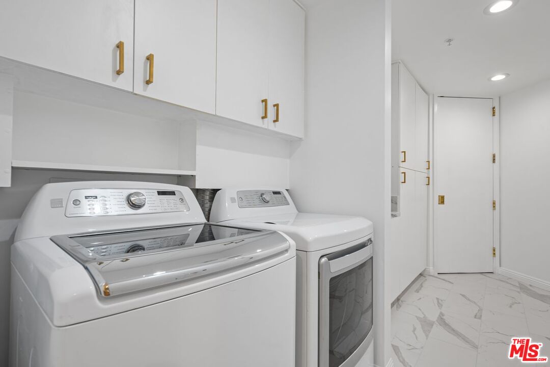 10490 Wilshire Boulevard, Unit 1004 Los Angeles, CA 90024 - Photo 38 of 45 a utility room with dryer and washer