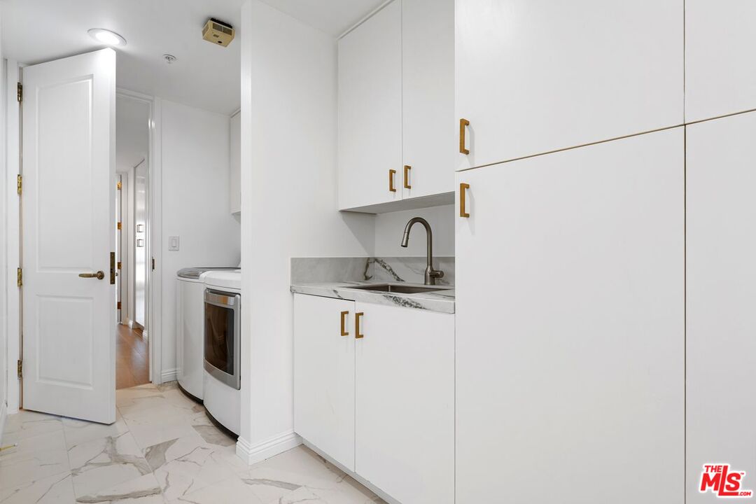 10490 Wilshire Boulevard, Unit 1004 Los Angeles, CA 90024 - Photo 39 of 45 a kitchen with a sink and refrigerator