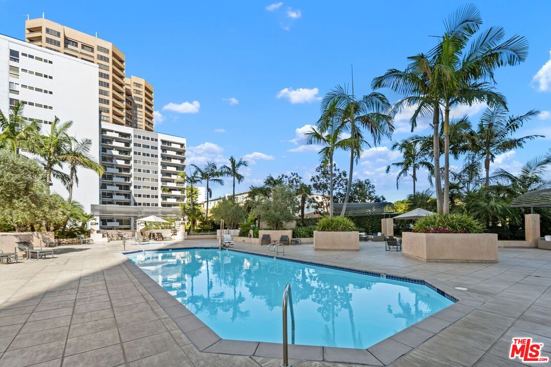 10490 Wilshire Boulevard, Unit 1004 Los Angeles, CA 90024 - Photo 40 of 45 a view of a swimming pool with a lounge chair