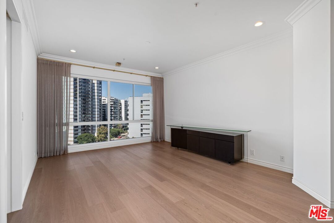 10490 Wilshire Boulevard, Unit 1004 Los Angeles, CA 90024 - Photo 6 of 45 wooden floor in an empty room with a window