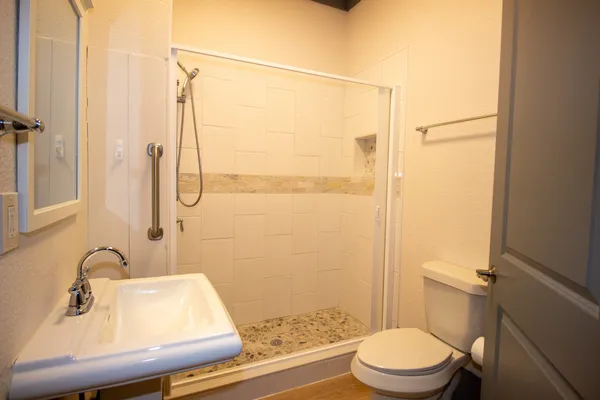 a bathroom with a sink toilet and shower