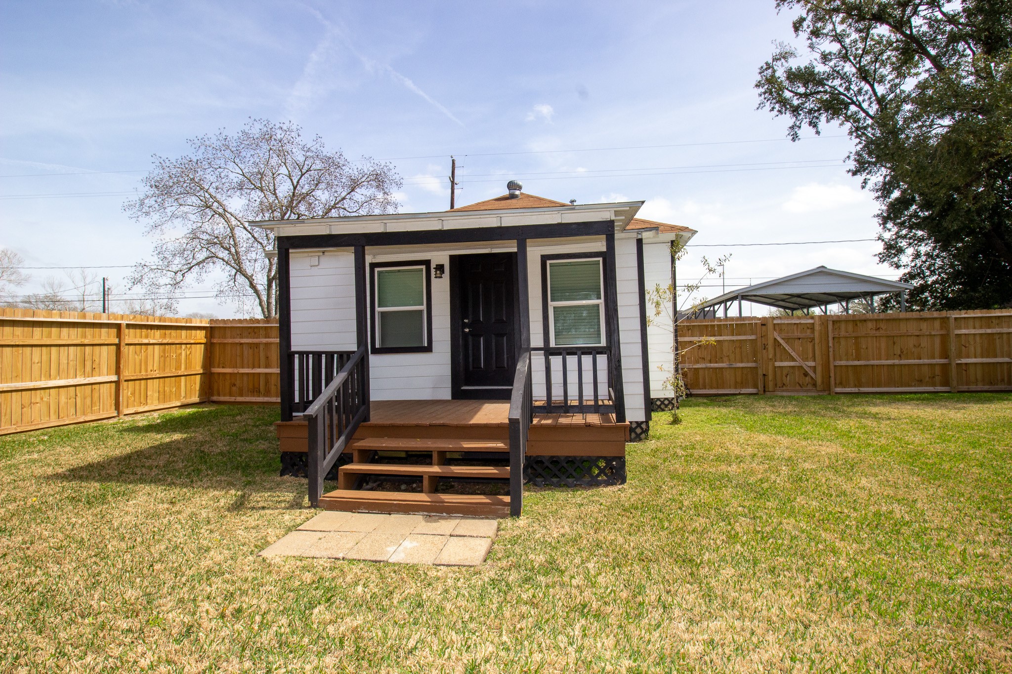 1819 Key Street Waller, TX 77484 - Photo 16 of 19 a view of a backyard with couches plants and large tree