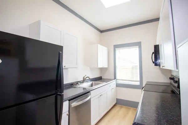 a kitchen with a refrigerator and a sink
