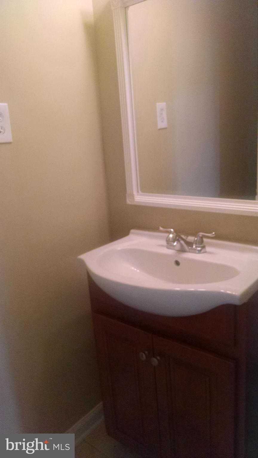 3493 Salem Bottom Road Westminster, MD 21157 - Photo 23 of 30 a bathroom with a sink and a mirror
