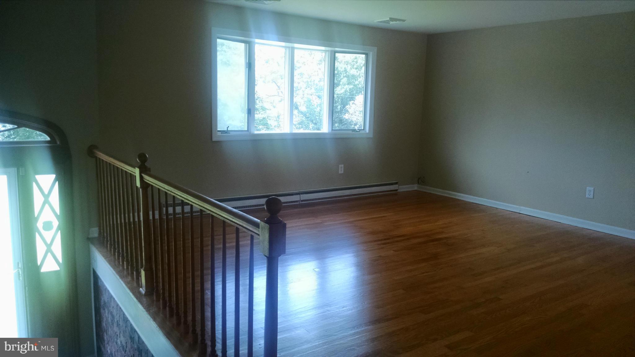 3493 Salem Bottom Road Westminster, MD 21157 - Photo 8 of 30 a view of an empty room with wooden floor and fan