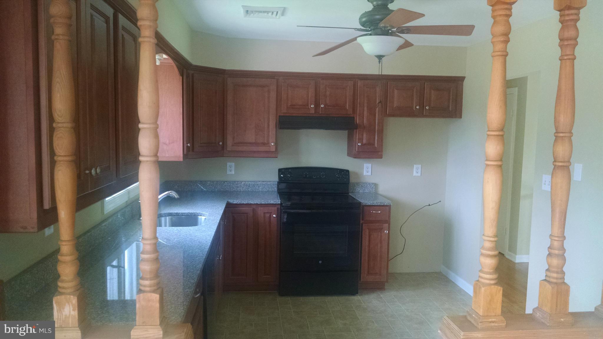 3493 Salem Bottom Road Westminster, MD 21157 - Photo 10 of 30 a kitchen with a refrigerator and a stove top oven