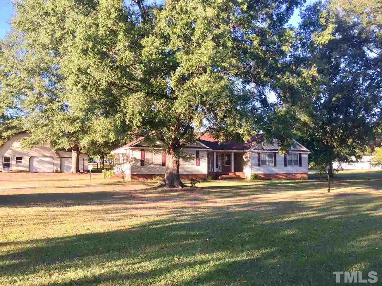 1088 Glover Road Dunn, NC 28334 - Photo 5 of 24 a front view of a building with trees