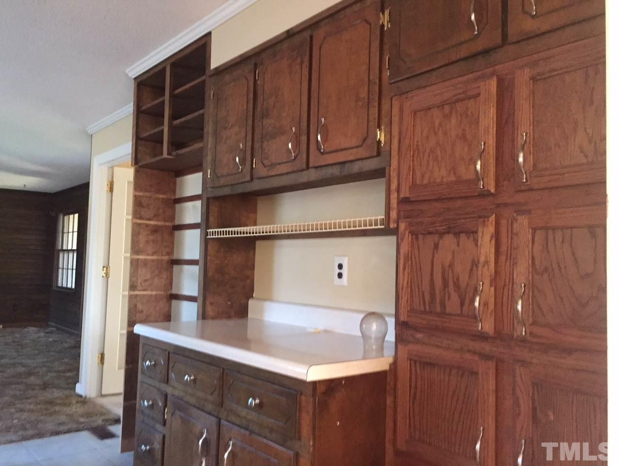 1088 Glover Road Dunn, NC 28334 - Photo 8 of 24 a kitchen with wooden cabinets and a sink