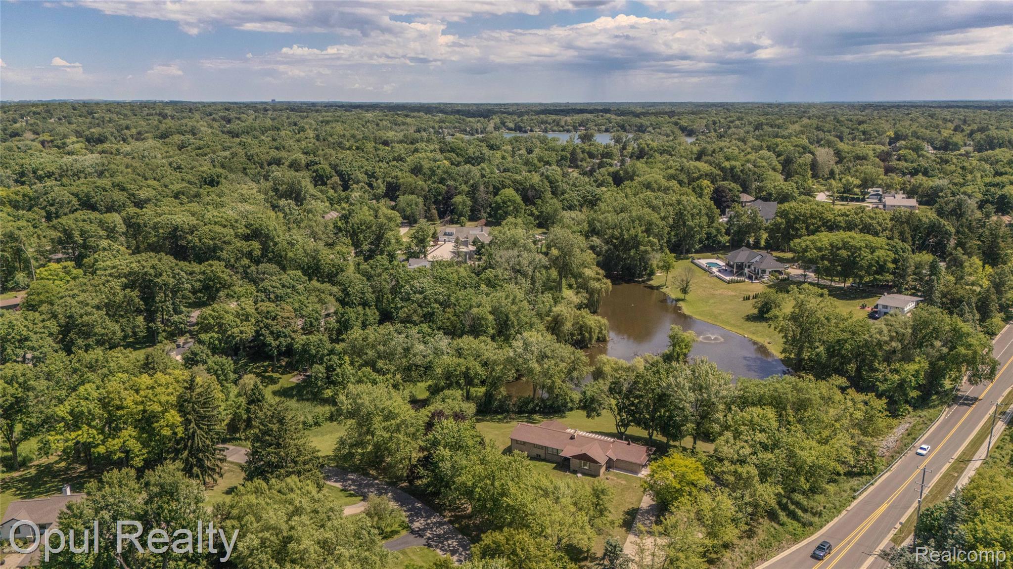 6455 Norham Road Bloomfield Hills, MI 48301 - Photo 87 of 93 Aerial perspective showcasing a residential area surrounded by abundant mature trees and natural landscaping