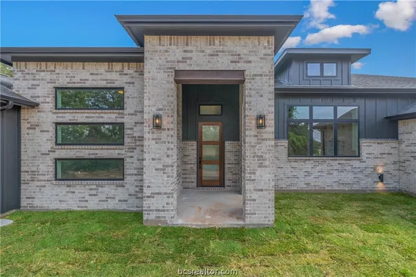 a view of front door of house with yard