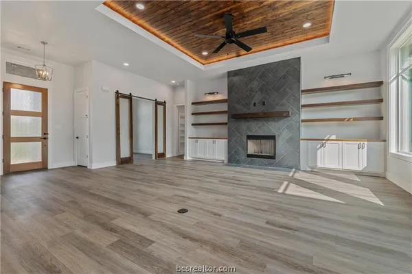 an empty room with wooden floor and window