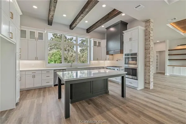 a kitchen with a sink appliances and cabinets