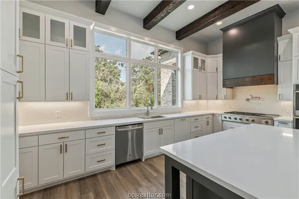 a kitchen with a stove a sink and a refrigerator