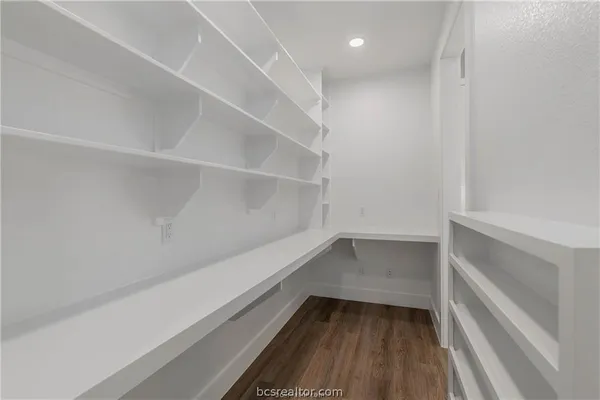 a room that has a bench and a wooden floor