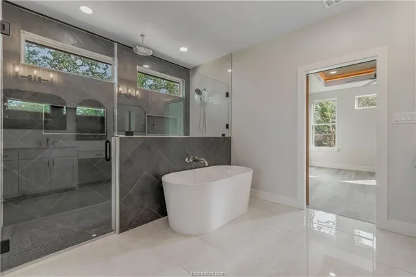 a bathroom with a bathtub and shower