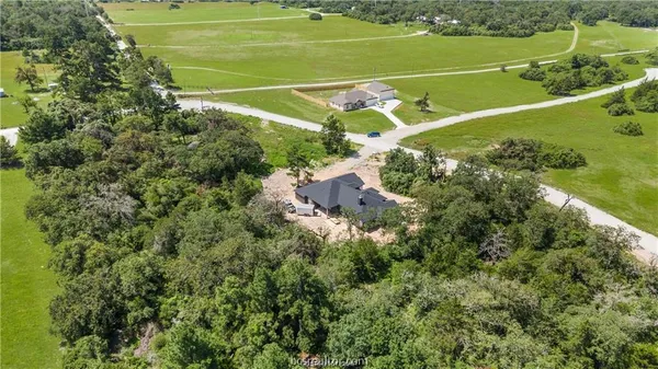 a view of a tennis ground with a small park