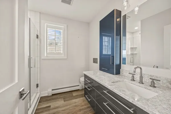 a bathroom with a granite countertop sink and a mirror