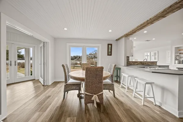 a dining room with furniture and wooden floor