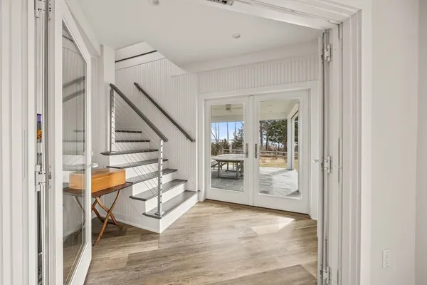 a view of an entryway with wooden floor and windows