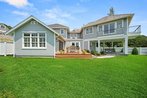 a front view of a house with garden and patio