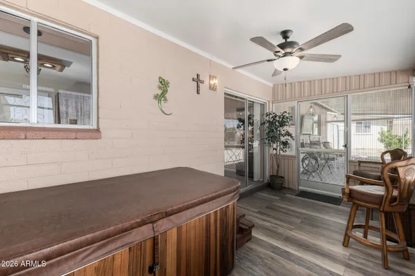 a view of a livingroom with wooden floor and a ceiling fan
