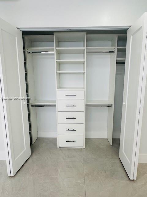 11870 Southwest 5th Street, Unit 1 Miami, FL 33184 - Photo 23 of 38 a view of walk in closet with empty racks