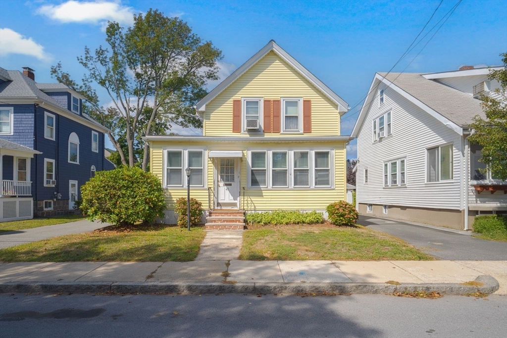 a view of a house with a yard in front of it
