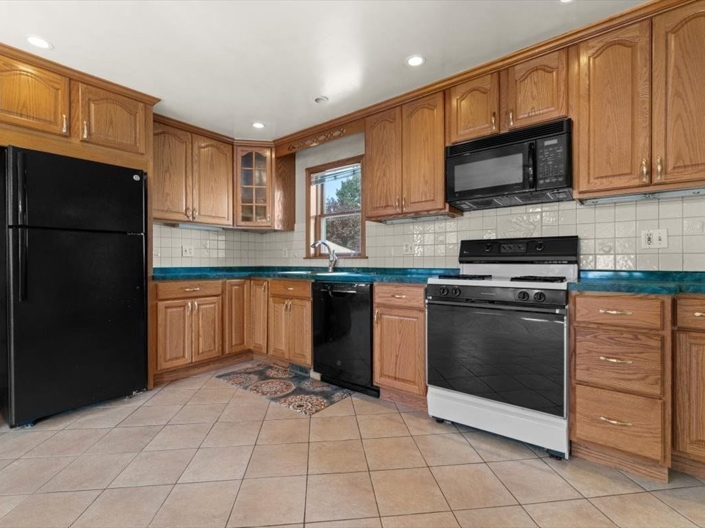 41 Sargent Street Winthrop, MA 02152 - Photo 19 of 40 a kitchen with stainless steel appliances granite countertop a stove top oven a sink dishwasher and a refrigerator