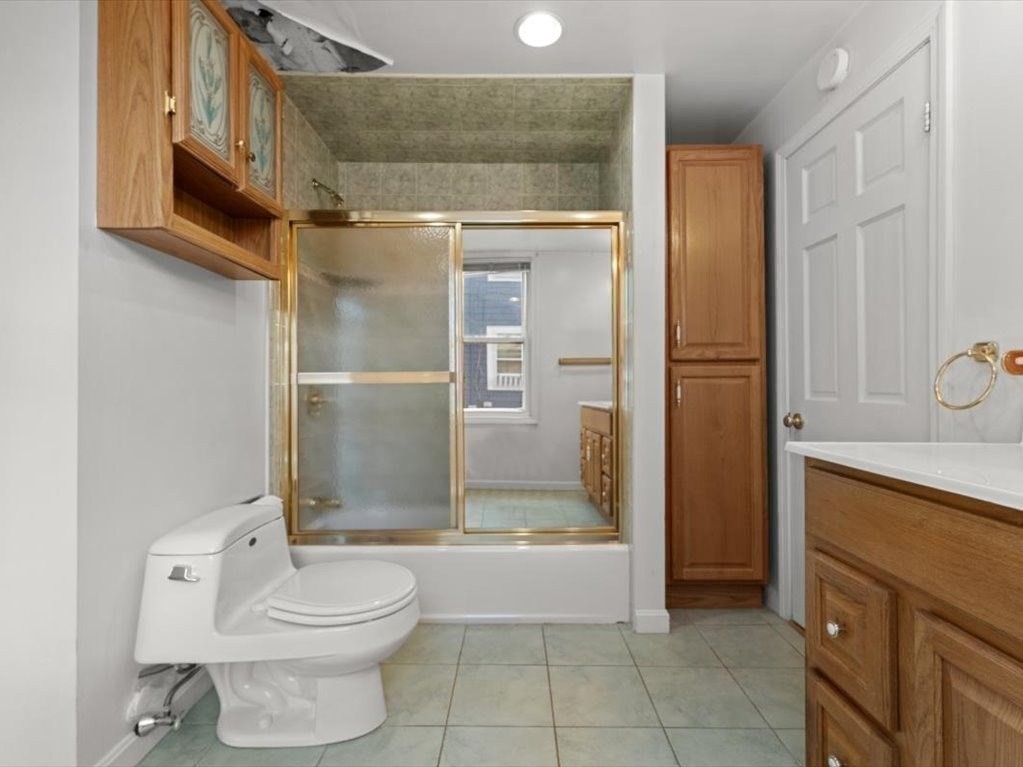 41 Sargent Street Winthrop, MA 02152 - Photo 27 of 40 a bathroom with a granite countertop bathtub shower sink mirror and toilet