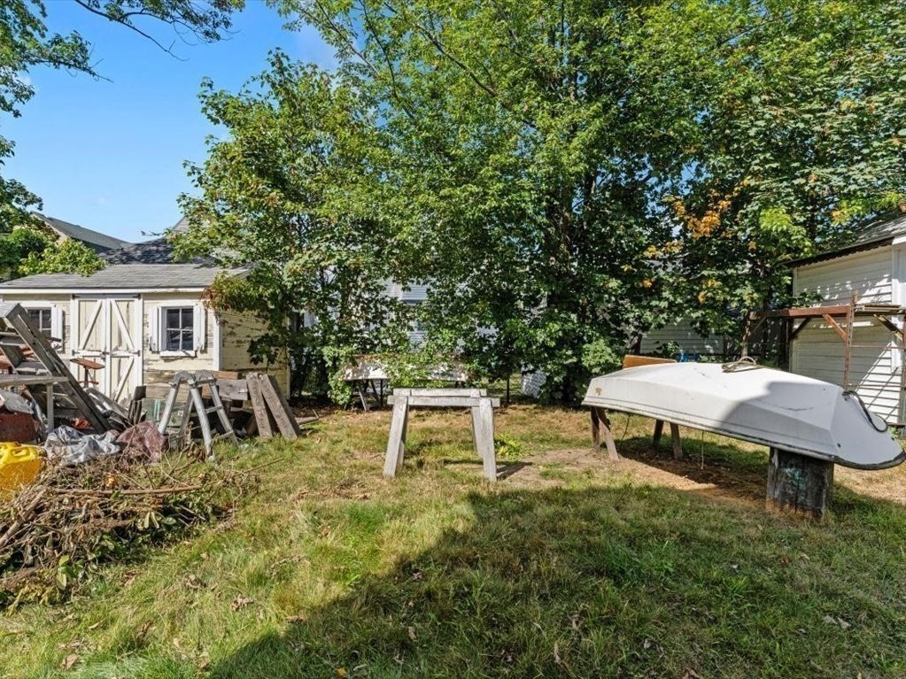 41 Sargent Street Winthrop, MA 02152 - Photo 7 of 40 a view of a backyard with table and chairs with wooden fence and plants