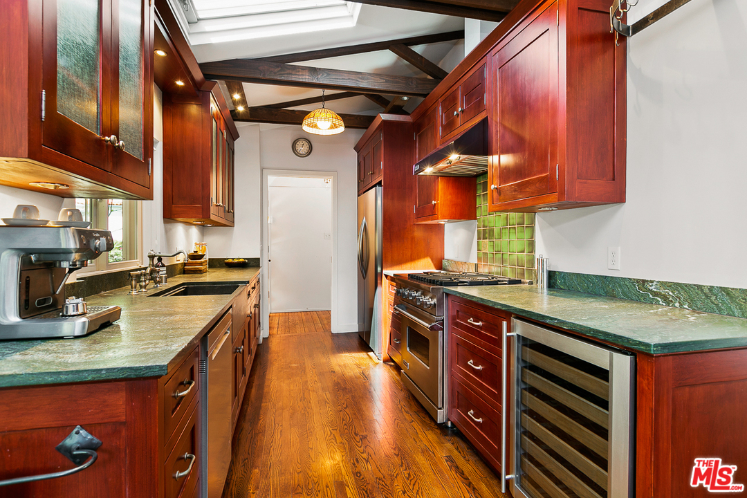 1600 Queens Road Los Angeles, CA 90069 - Photo 13 of 35 a kitchen with stainless steel appliances granite countertop a stove and a sink