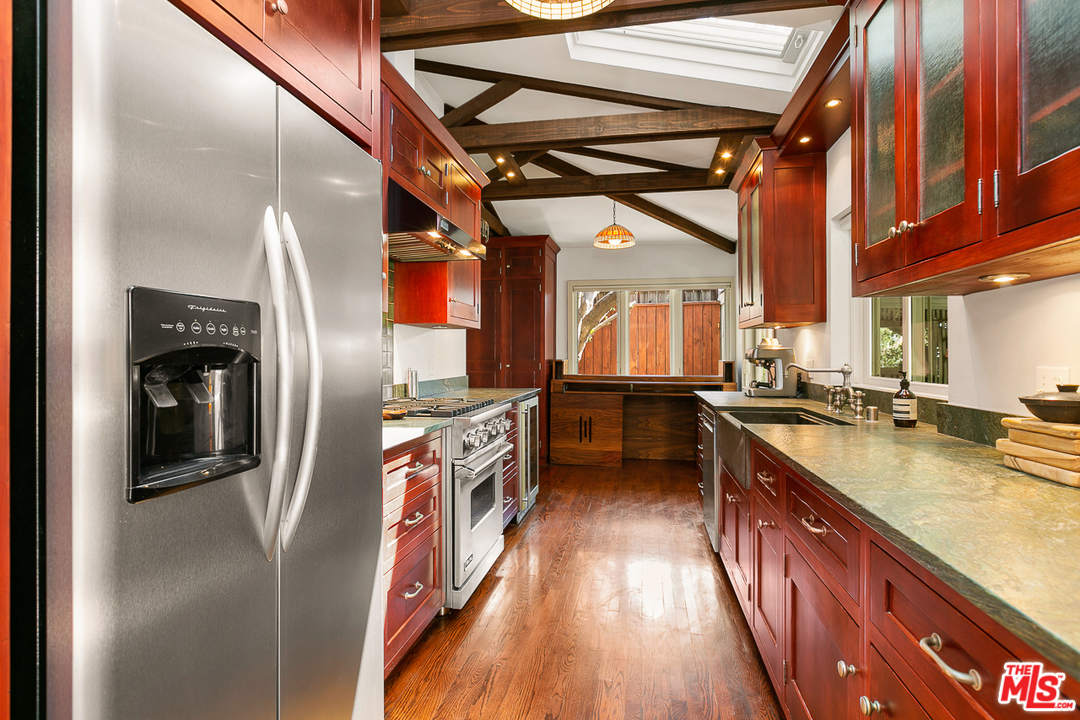 1600 Queens Road Los Angeles, CA 90069 - Photo 14 of 35 a kitchen with stainless steel appliances granite countertop a refrigerator a stove and a sink