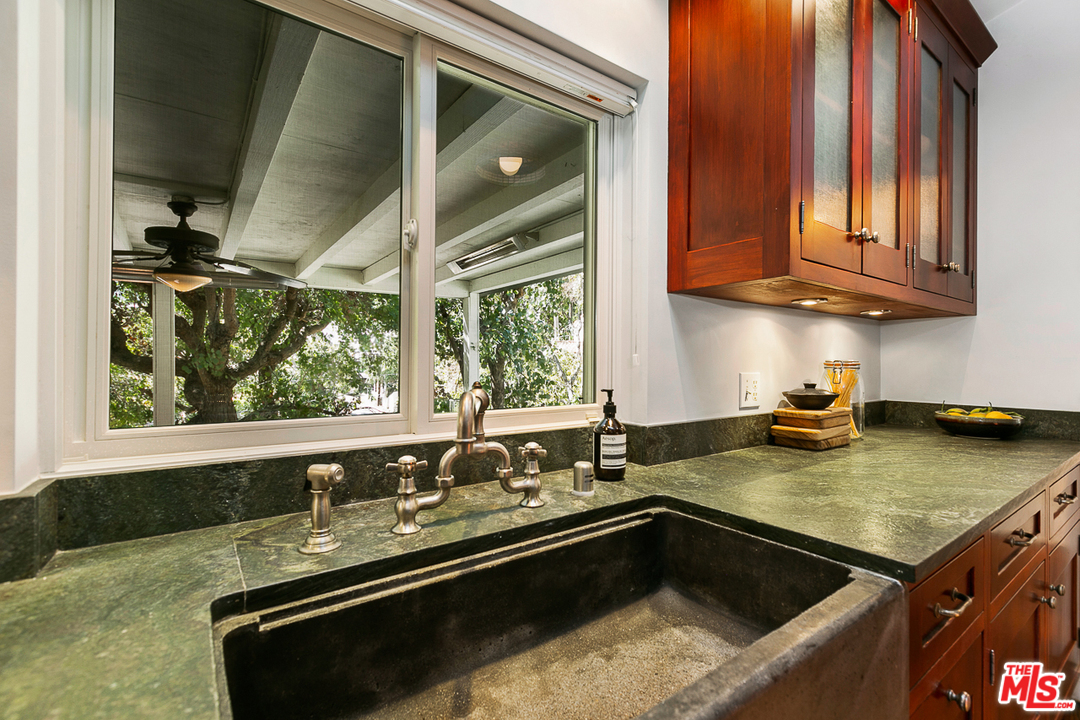 1600 Queens Road Los Angeles, CA 90069 - Photo 15 of 35 a kitchen with granite countertop a sink a stove and cabinets