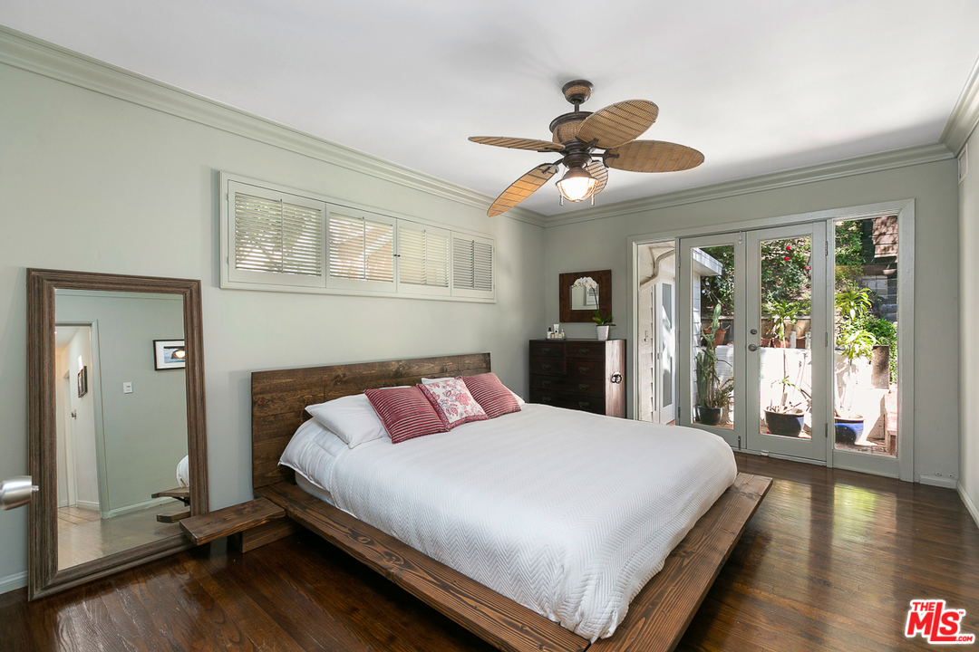 1600 Queens Road Los Angeles, CA 90069 - Photo 21 of 35 a bedroom with a large bed and a chandelier