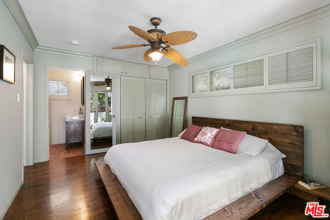 1600 Queens Road Los Angeles, CA 90069 - Photo 22 of 35 a bedroom with a bed and a chandelier