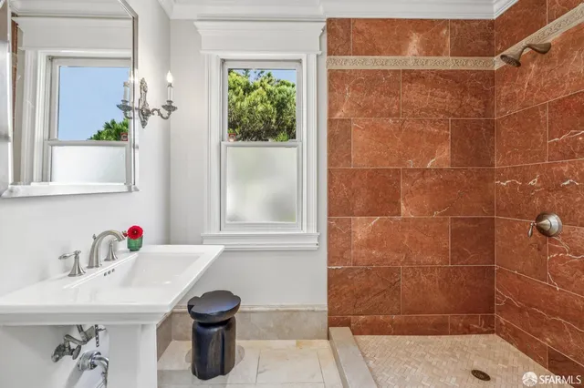 a bathroom with a granite countertop sink mirror and a bath tub