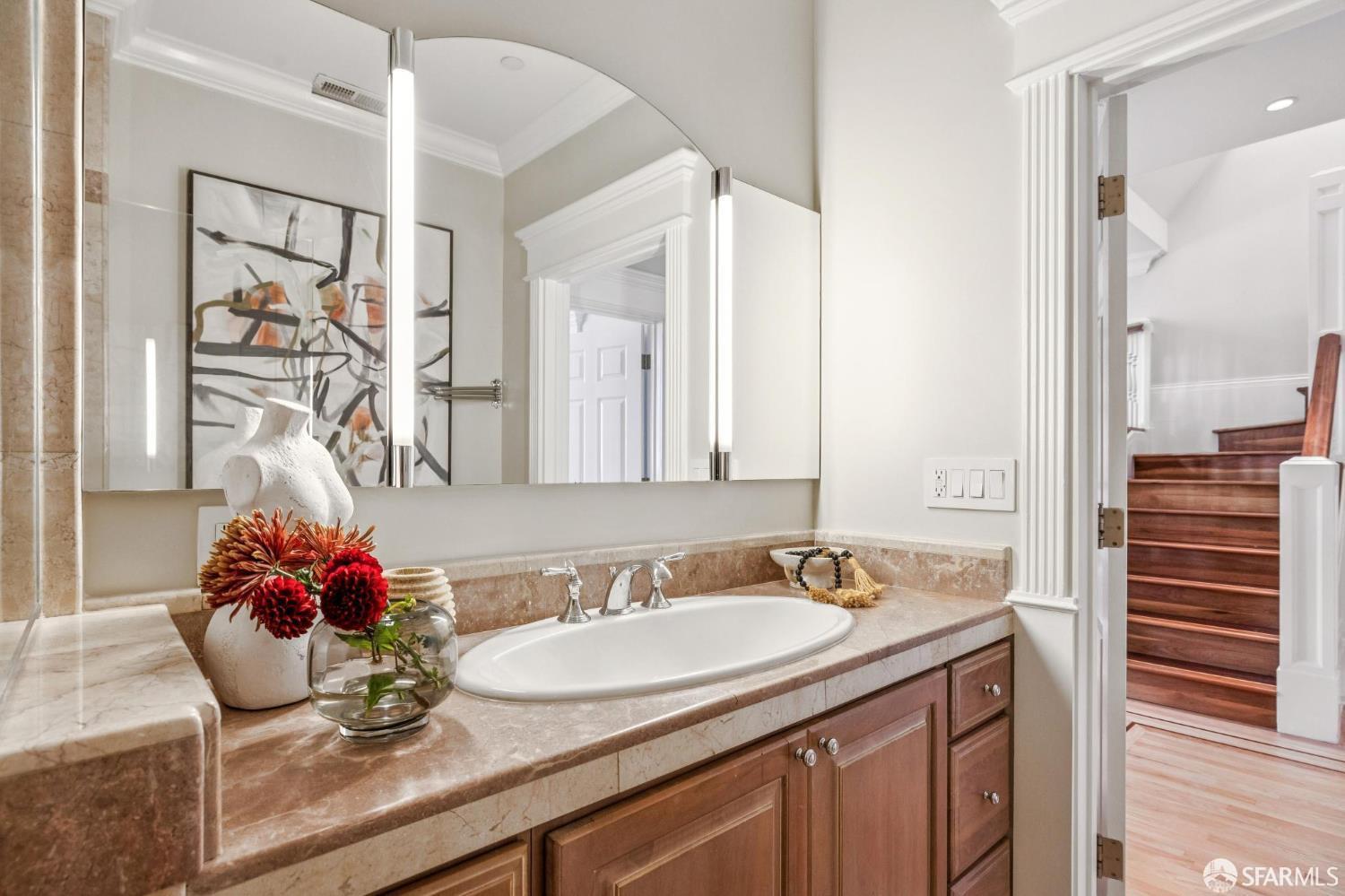 729 Douglass Street San Francisco, CA 94114 - Photo 36 of 79 a bathroom with a granite countertop sink and a mirror