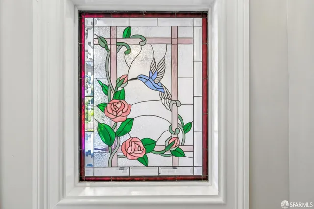 a living room with furniture potted plant and a large window