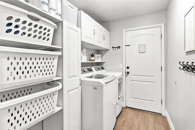 a kitchen with a refrigerator a sink and dishwasher with wooden floor