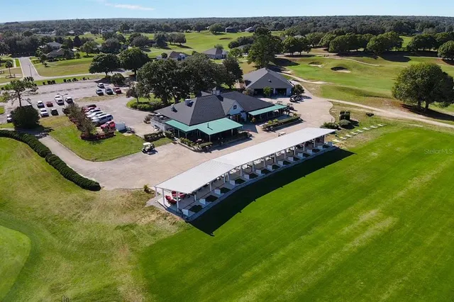 an aerial view of a residential houses with outdoor space