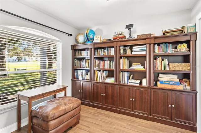 a bedroom with furniture and a book shelf