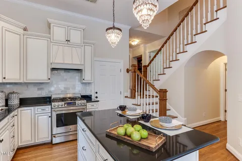 a kitchen with granite countertop a sink appliances and cabinets