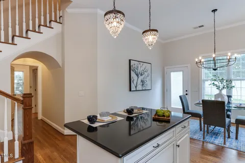 a kitchen with a sink a counter space appliances and cabinets