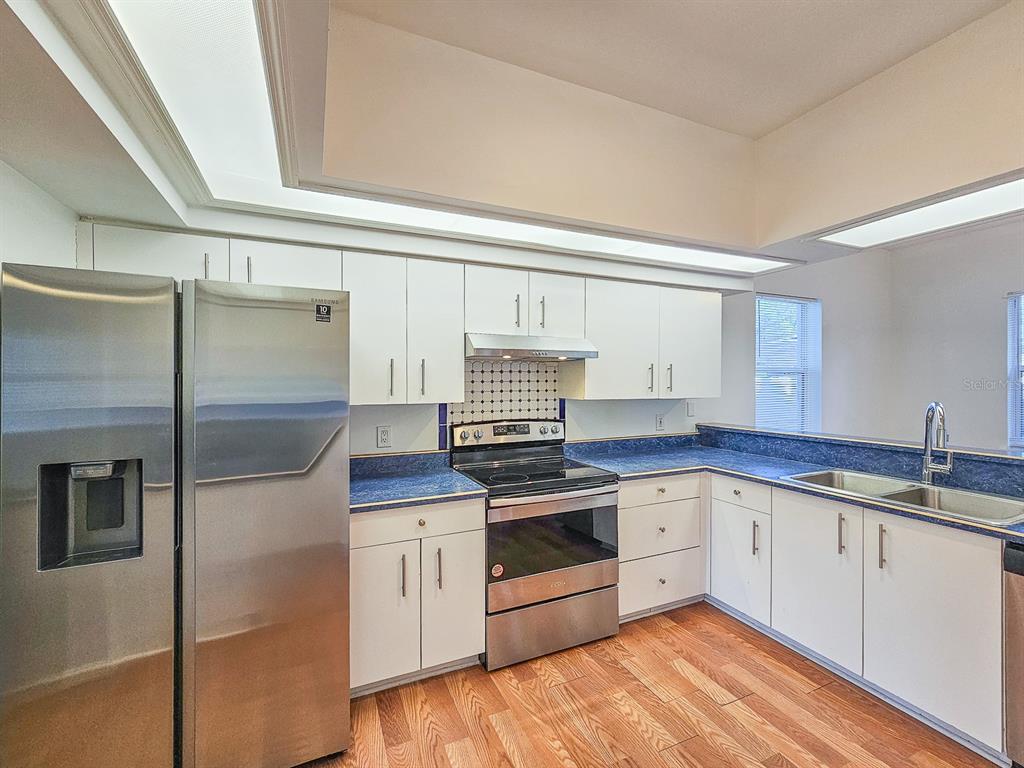 28 Botany Lane Palm Coast, FL 32137 - Photo 11 of 48 a kitchen with stainless steel appliances granite countertop a stove and a refrigerator