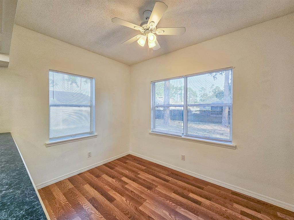 28 Botany Lane Palm Coast, FL 32137 - Photo 14 of 48 a view of an empty room with a window and a chandelier fan