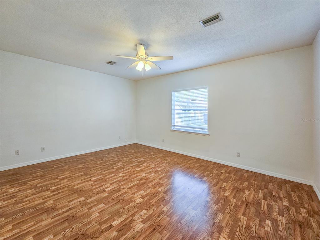 28 Botany Lane Palm Coast, FL 32137 - Photo 22 of 48 an empty room with wooden floor and windows