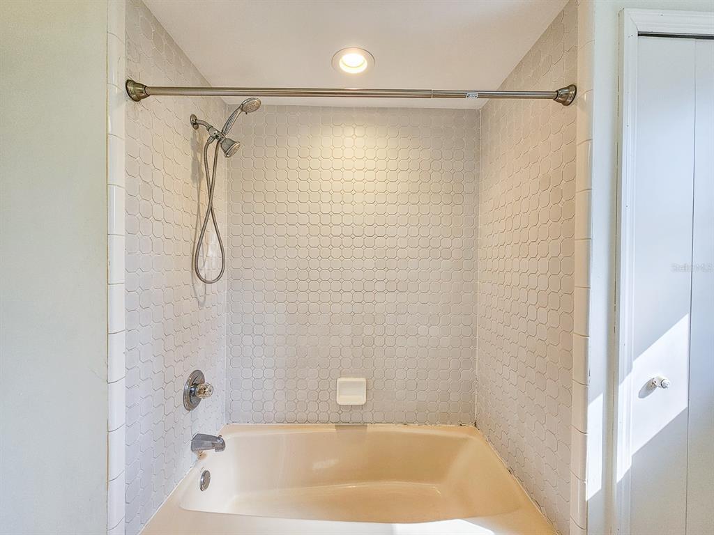 28 Botany Lane Palm Coast, FL 32137 - Photo 32 of 48 a bathroom with a shower and a bath tub