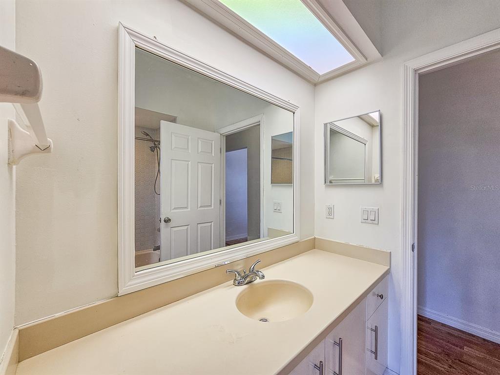 28 Botany Lane Palm Coast, FL 32137 - Photo 33 of 48 a bathroom with a granite countertop sink and a mirror