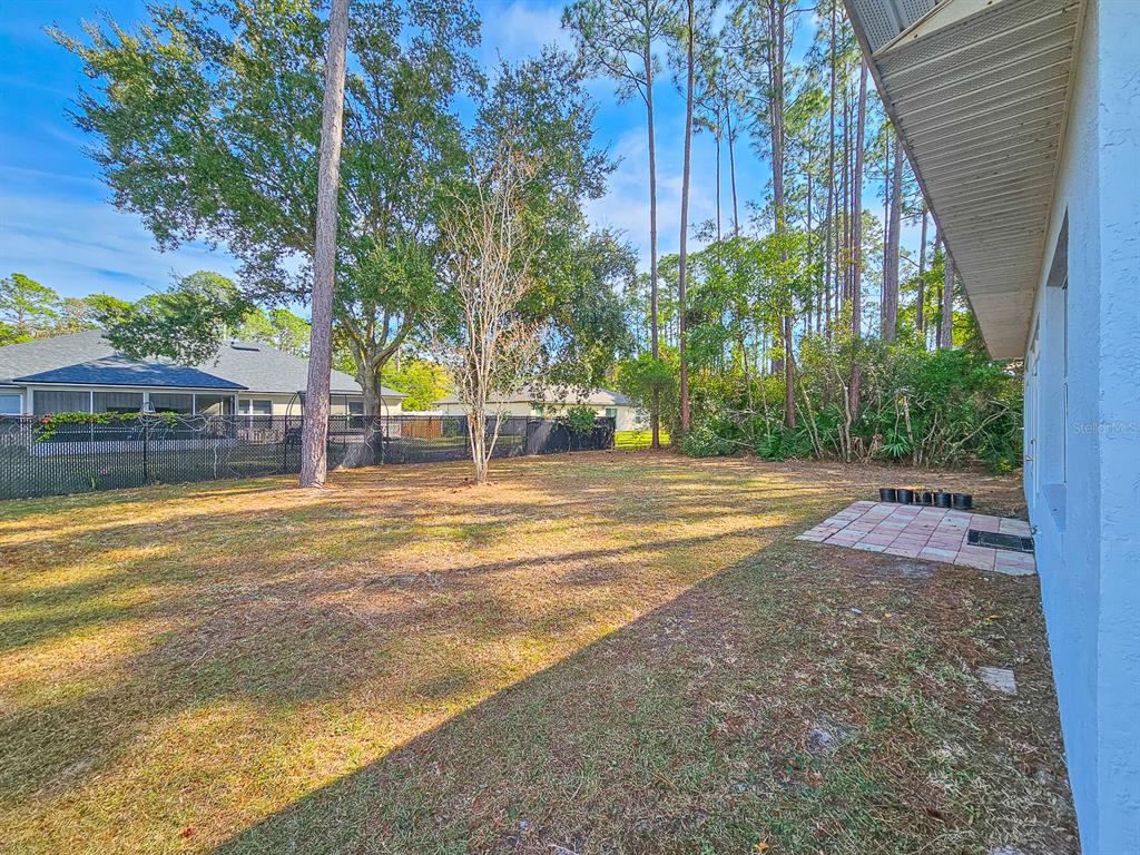 28 Botany Lane Palm Coast, FL 32137 - Photo 37 of 48 a view of swimming pool with lawn chairs and plants