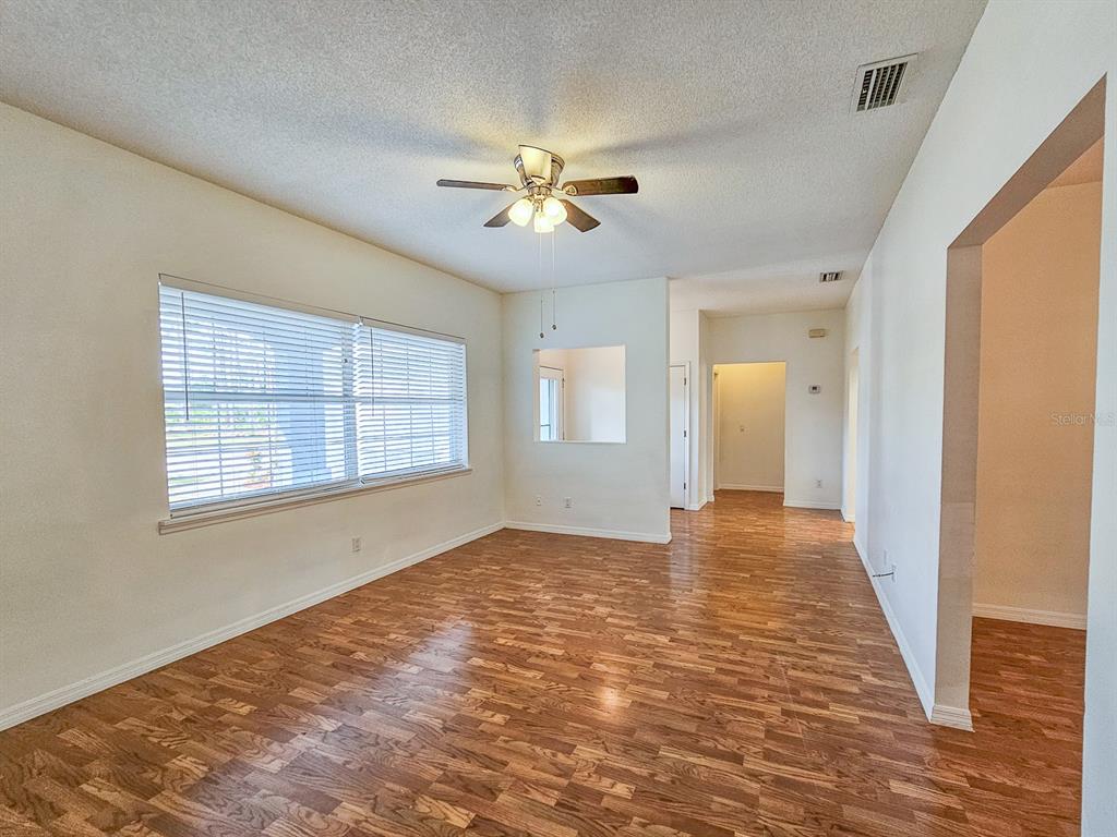 28 Botany Lane Palm Coast, FL 32137 - Photo 7 of 48 a view of an empty room with window and wooden floor